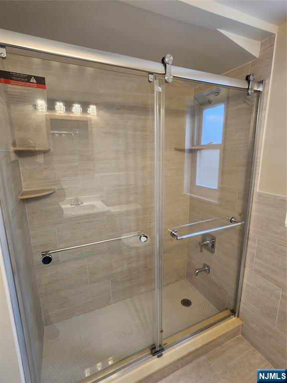111 Church Street Lodi, NJ 07644 - Photo 15 of 21 a bathroom with a glass door shower