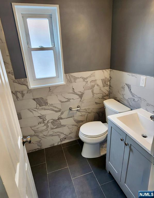 111 Church Street Lodi, NJ 07644 - Photo 16 of 21 a bathroom with a toilet sink and mirror
