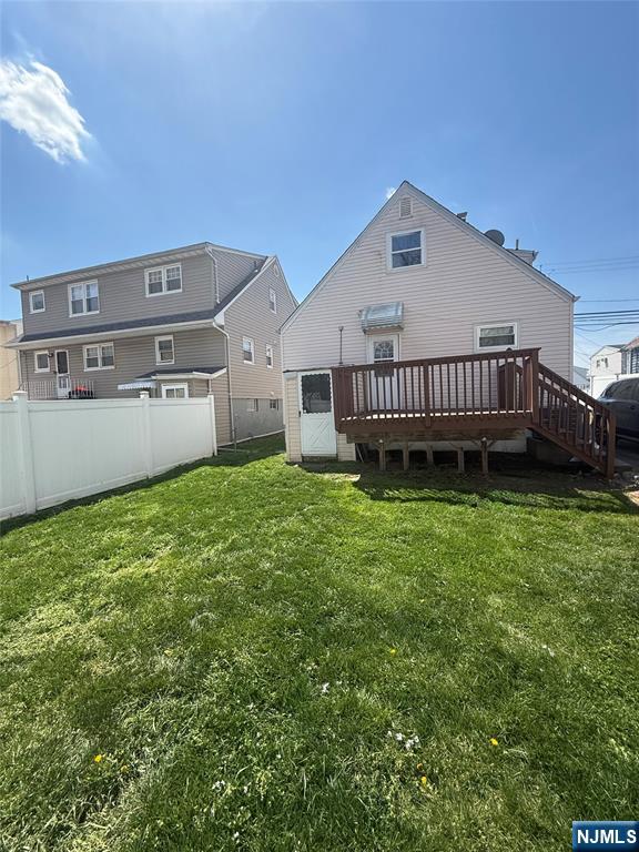 111 Church Street Lodi, NJ 07644 - Photo 2 of 21 a view of a house with a backyard and deck