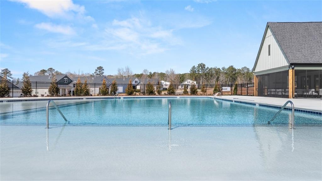 636 Parnassus Road Locust Grove, GA 30248 - Photo 13 of 44 a view of a swimming pool with a lake view