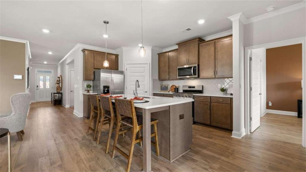 636 Parnassus Road Locust Grove, GA 30248 - Photo 18 of 44 a kitchen with a sink a counter top space stainless steel appliances and cabinets