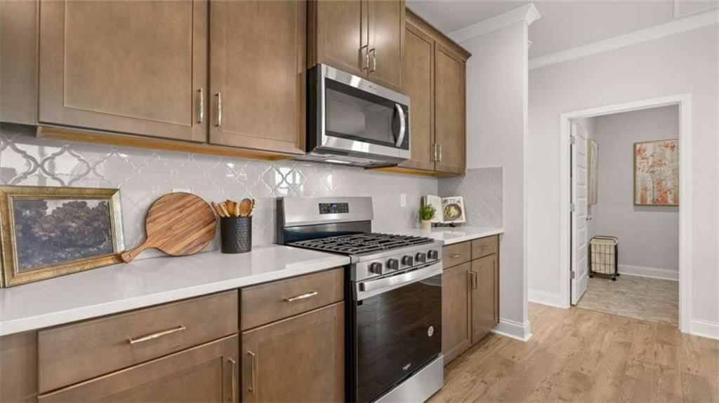 636 Parnassus Road Locust Grove, GA 30248 - Photo 19 of 44 a kitchen with stainless steel appliances granite countertop a sink a stove and a microwave