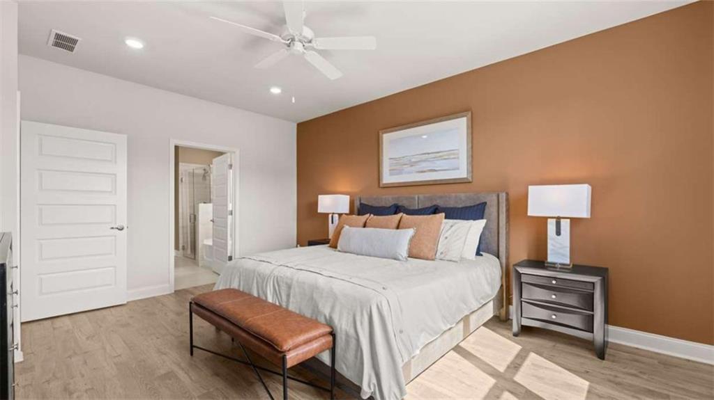 636 Parnassus Road Locust Grove, GA 30248 - Photo 24 of 44 a bedroom with a bed and a lamp