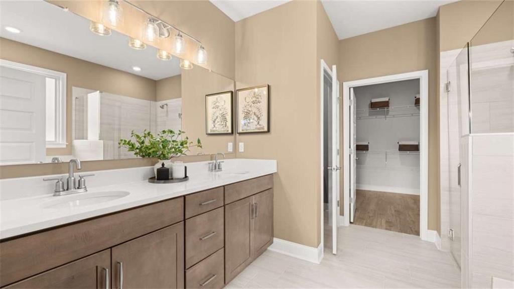 636 Parnassus Road Locust Grove, GA 30248 - Photo 25 of 44 a bathroom with a sink double vanity and a mirror