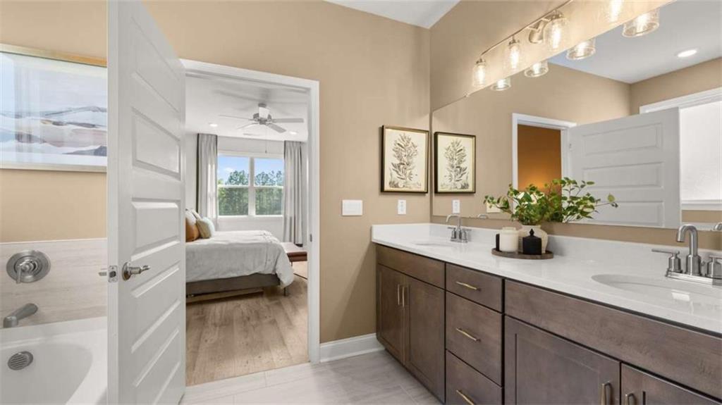 636 Parnassus Road Locust Grove, GA 30248 - Photo 26 of 44 a en suite spacious bathroom with a tub double sink and mirror