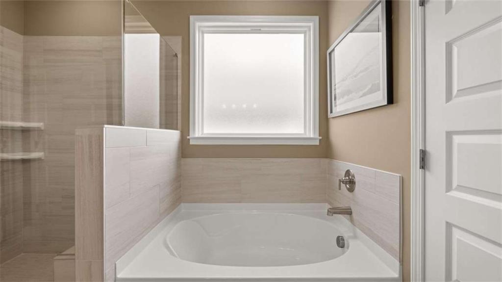 636 Parnassus Road Locust Grove, GA 30248 - Photo 27 of 44 a white bath tub sitting next to a window