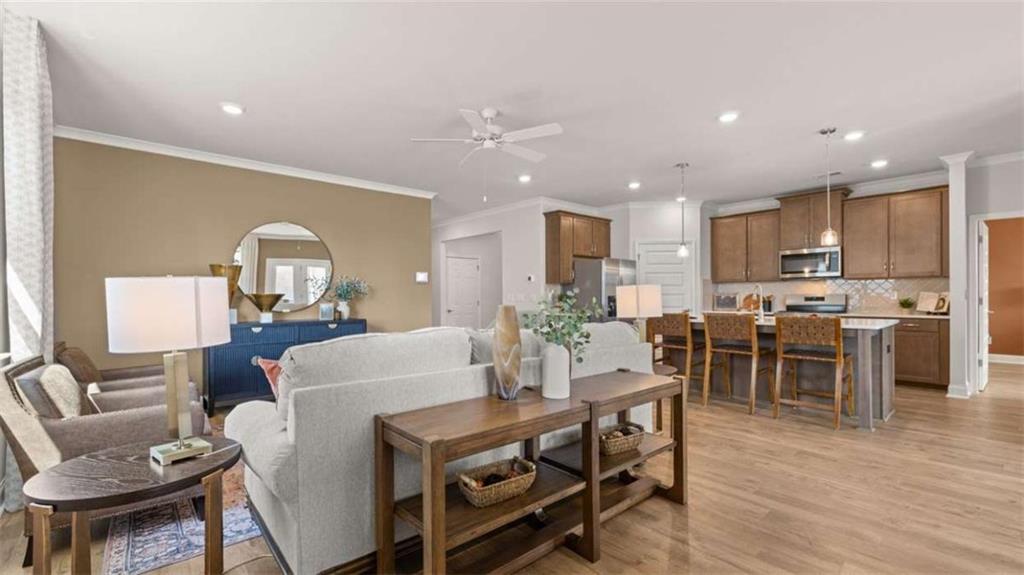 636 Parnassus Road Locust Grove, GA 30248 - Photo 32 of 44 a view of a dining room with furniture and wooden floor