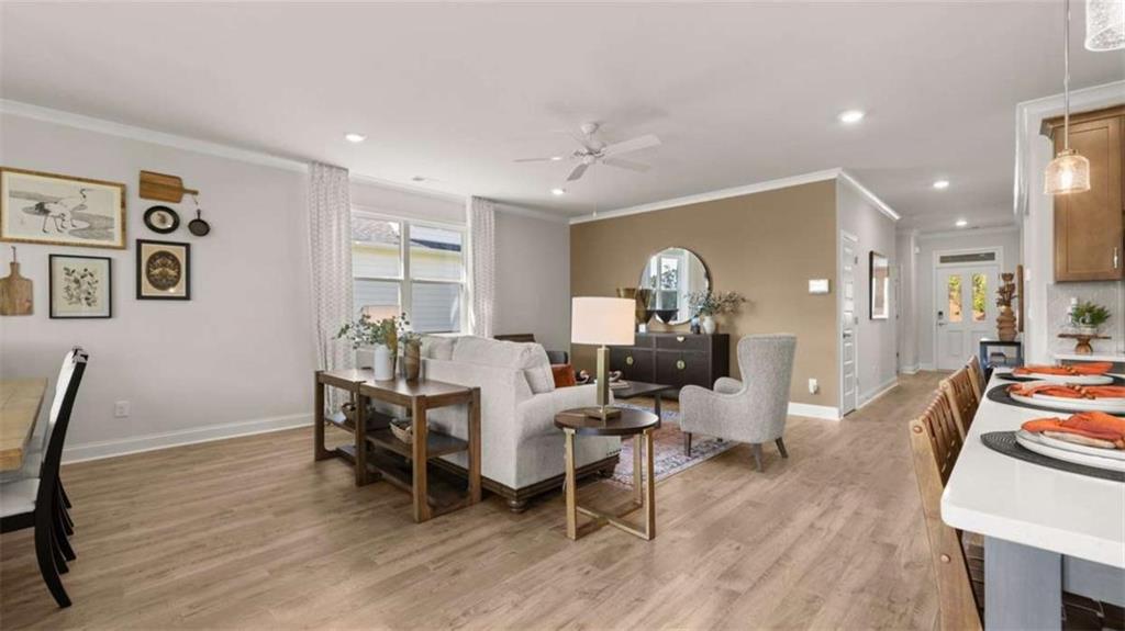 636 Parnassus Road Locust Grove, GA 30248 - Photo 35 of 44 a view of a dining room with furniture and wooden floor