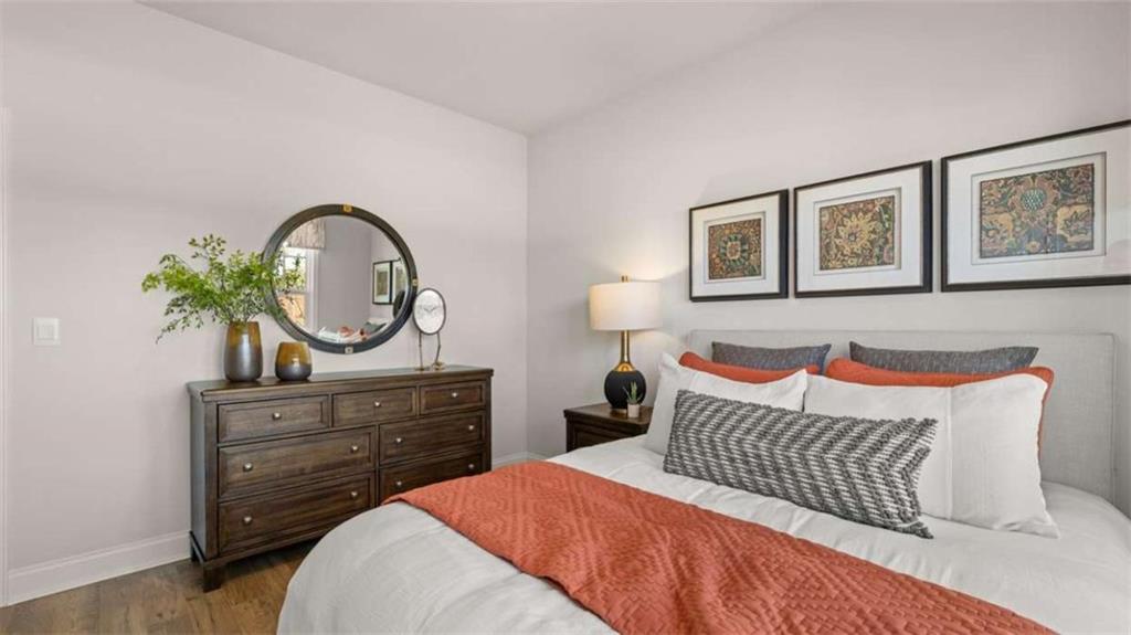 636 Parnassus Road Locust Grove, GA 30248 - Photo 38 of 44 a bedroom with a bed and wooden floor