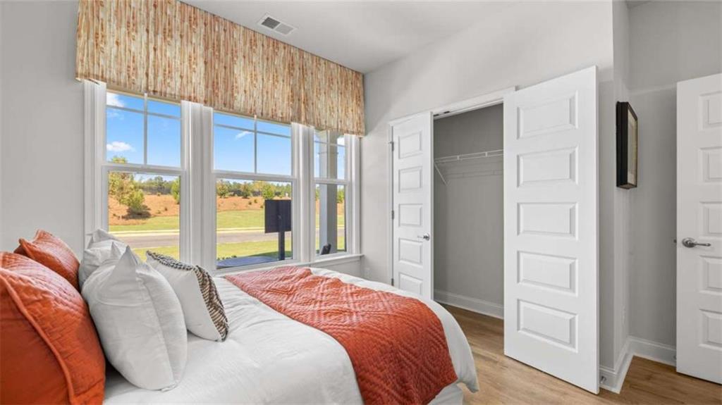 636 Parnassus Road Locust Grove, GA 30248 - Photo 39 of 44 a bedroom with a bed and a large window