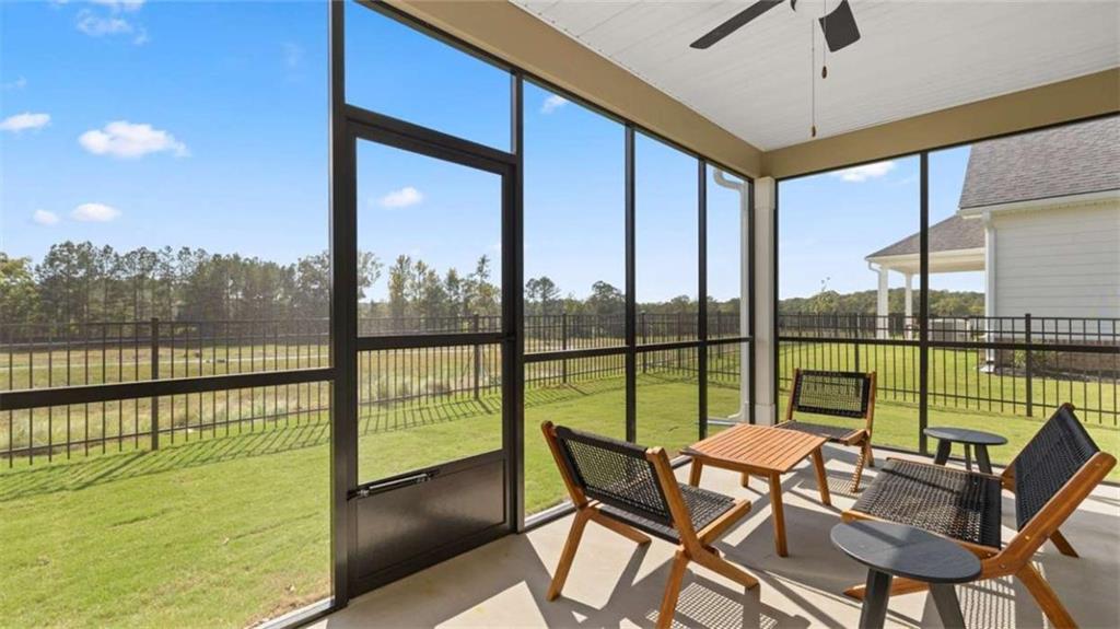 636 Parnassus Road Locust Grove, GA 30248 - Photo 40 of 44 a view of a city from a dining room with large windows