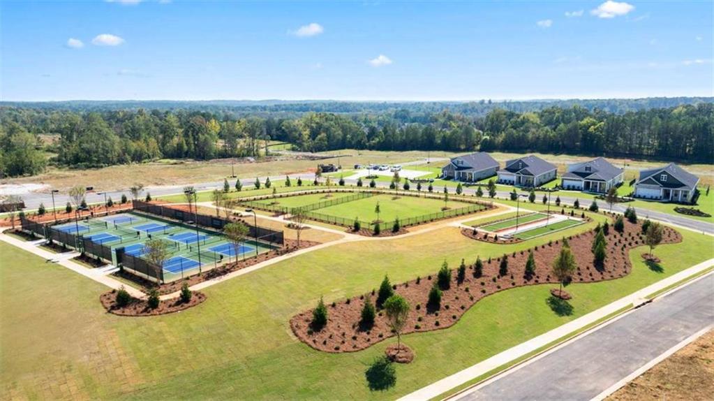 636 Parnassus Road Locust Grove, GA 30248 - Photo 6 of 44 a view of a swimming pool with chairs