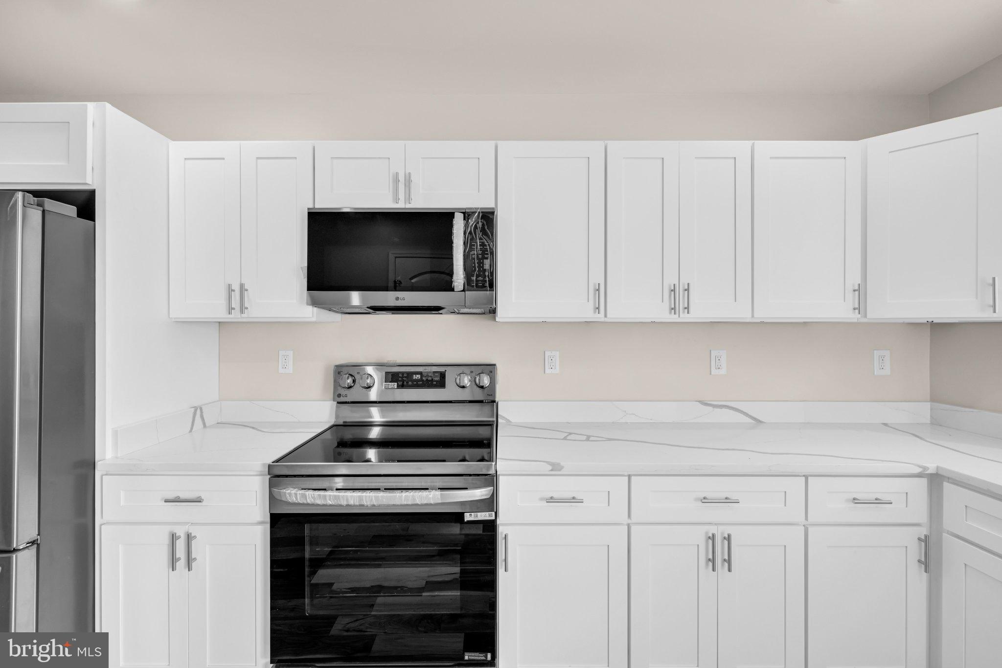 1622 Hazel Street Baltimore, MD 21226 - Photo 5 of 40 Sleek modern kitchen with white cabinetry.