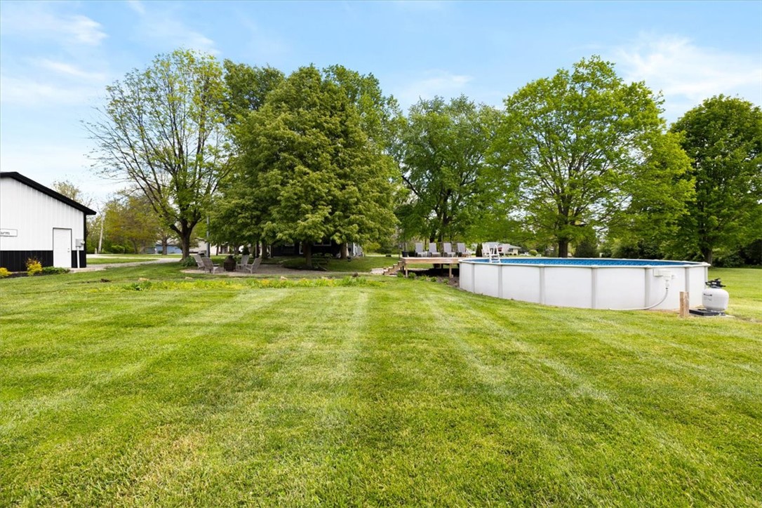 5120 Wheelock Road Troy, OH 45373 - Photo 50 of 67 This verdant outdoor space features a refreshing above-ground pool and ample room for recreation.
