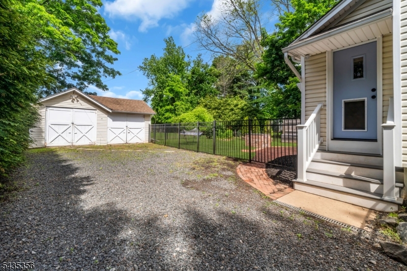 105 Somerville Road Bedminster, NJ 07921 - Photo 30 of 36 a view of backyard with wooden fence and large trees