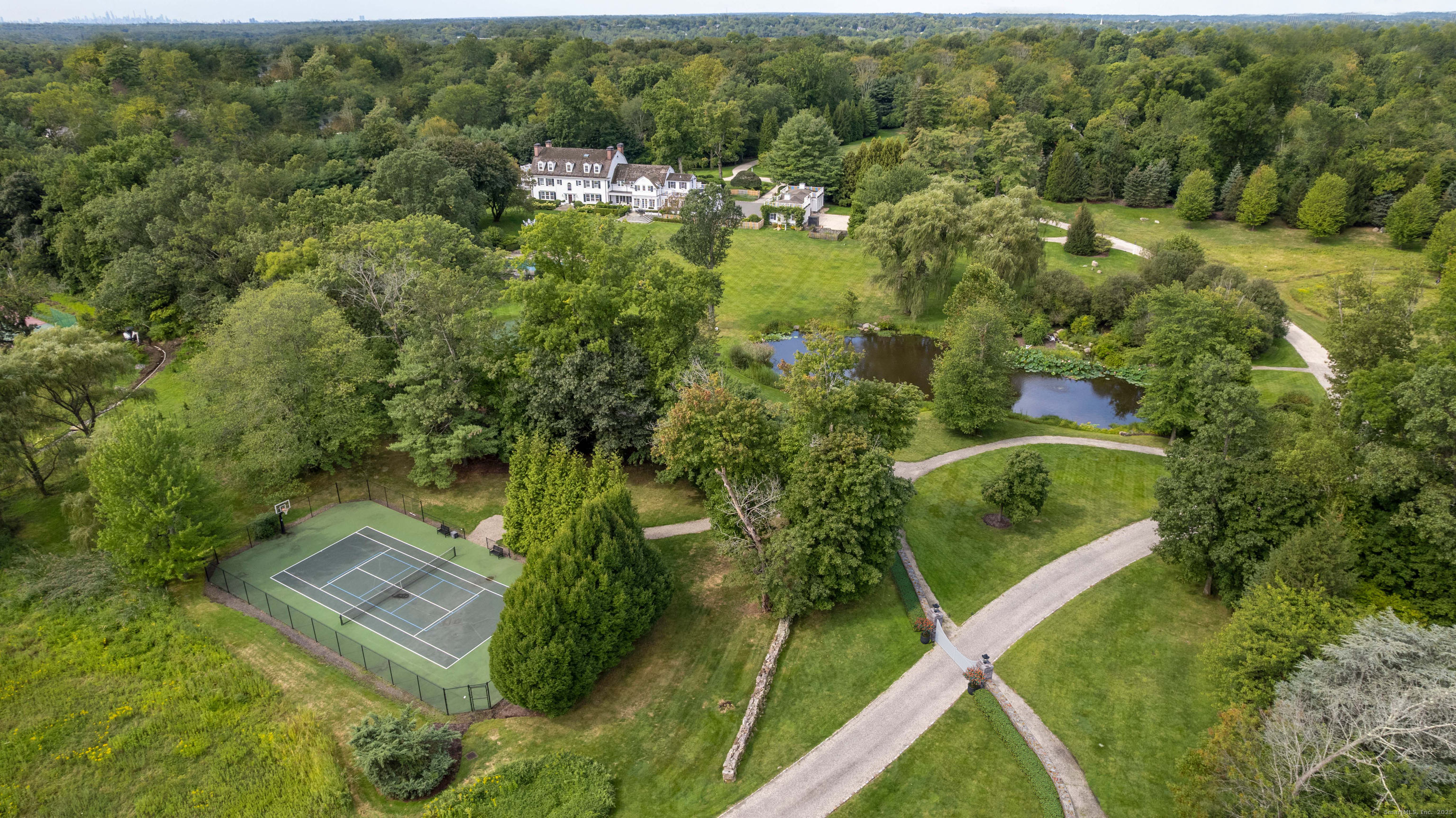 1619 Purchase Street Harrison, NY 10577 - Photo 1 of 37 an aerial view of residential house with outdoor space and trees all around