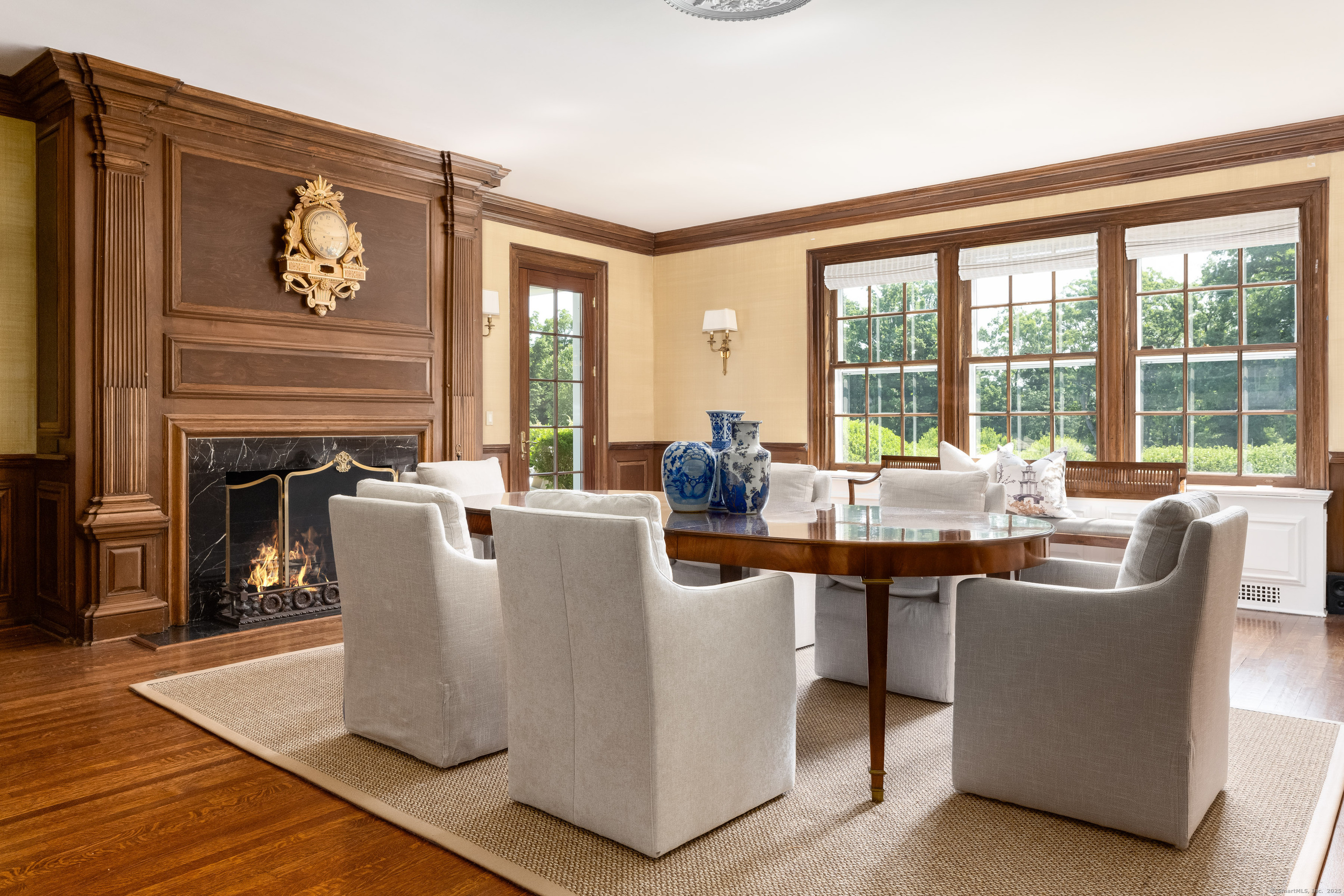 1619 Purchase Street Harrison, NY 10577 - Photo 17 of 37 a living room with couches a coffee table and a fireplace with wooden floor