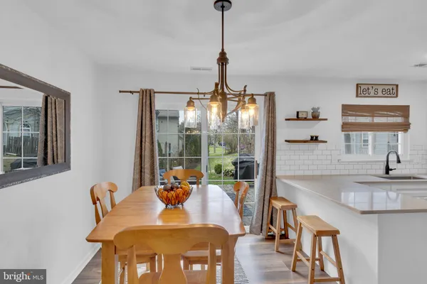 a kitchen with a refrigerator and a stove top oven