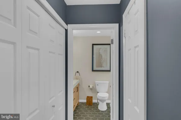 a bathroom with a sink and mirror with toilet