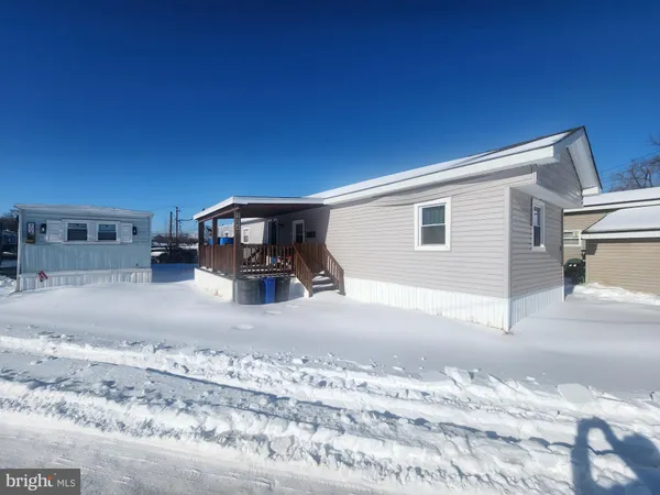 a view of a livingroom with wooden furniture