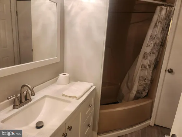 a bathroom with a sink and mirror
