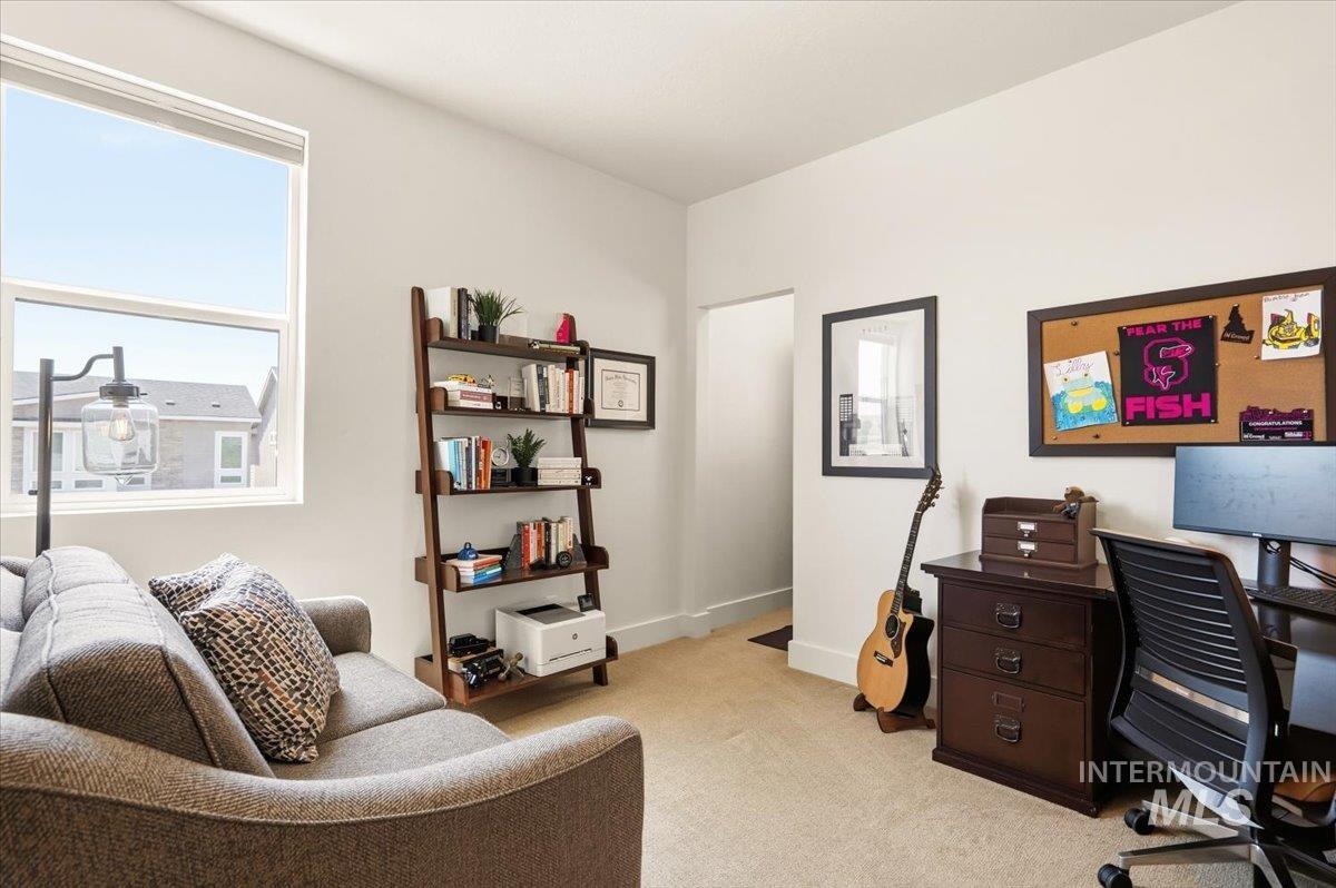 3794 South Single Tree Avenue Boise, ID 83716 - Photo 34 of 50 Bright room with a large window, neutral wall paint, and light-toned carpet flooring