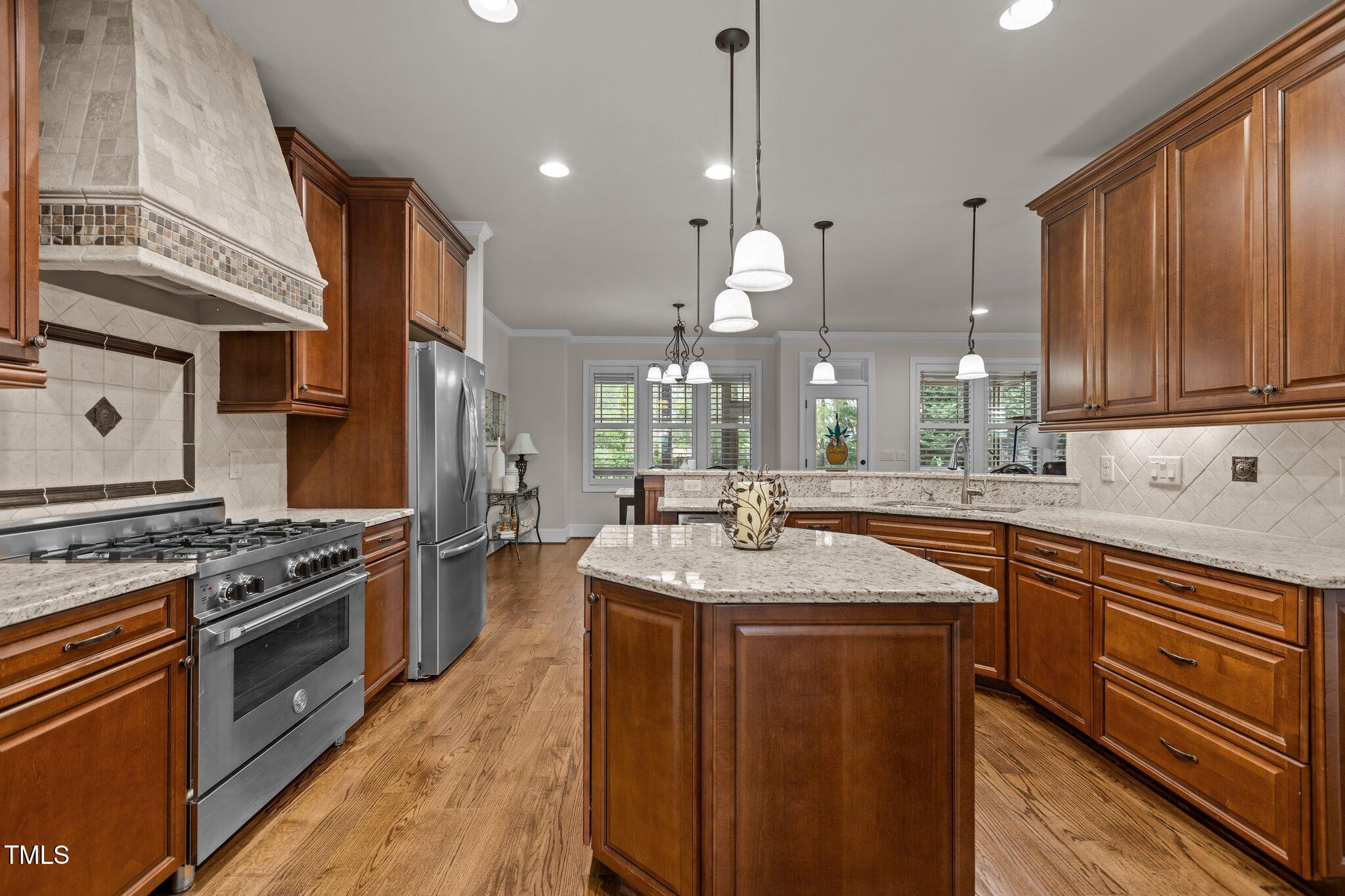 1512 Piazzo Court Apex, NC 27502 - Photo 11 of 59 a kitchen with stainless steel appliances granite countertop a sink a stove and a wooden floors