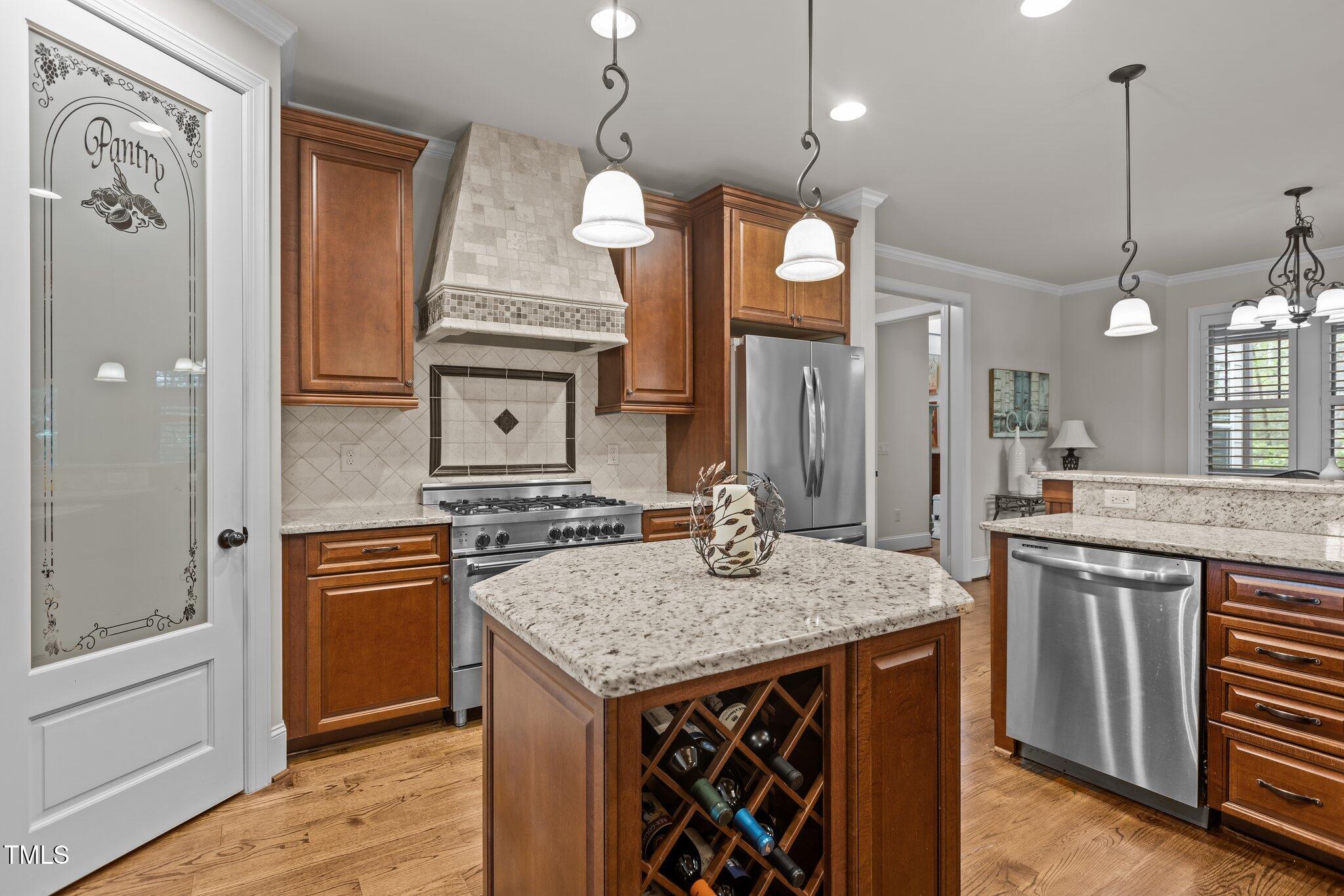 1512 Piazzo Court Apex, NC 27502 - Photo 12 of 59 a kitchen with stainless steel appliances granite countertop a sink a stove and a wooden floor