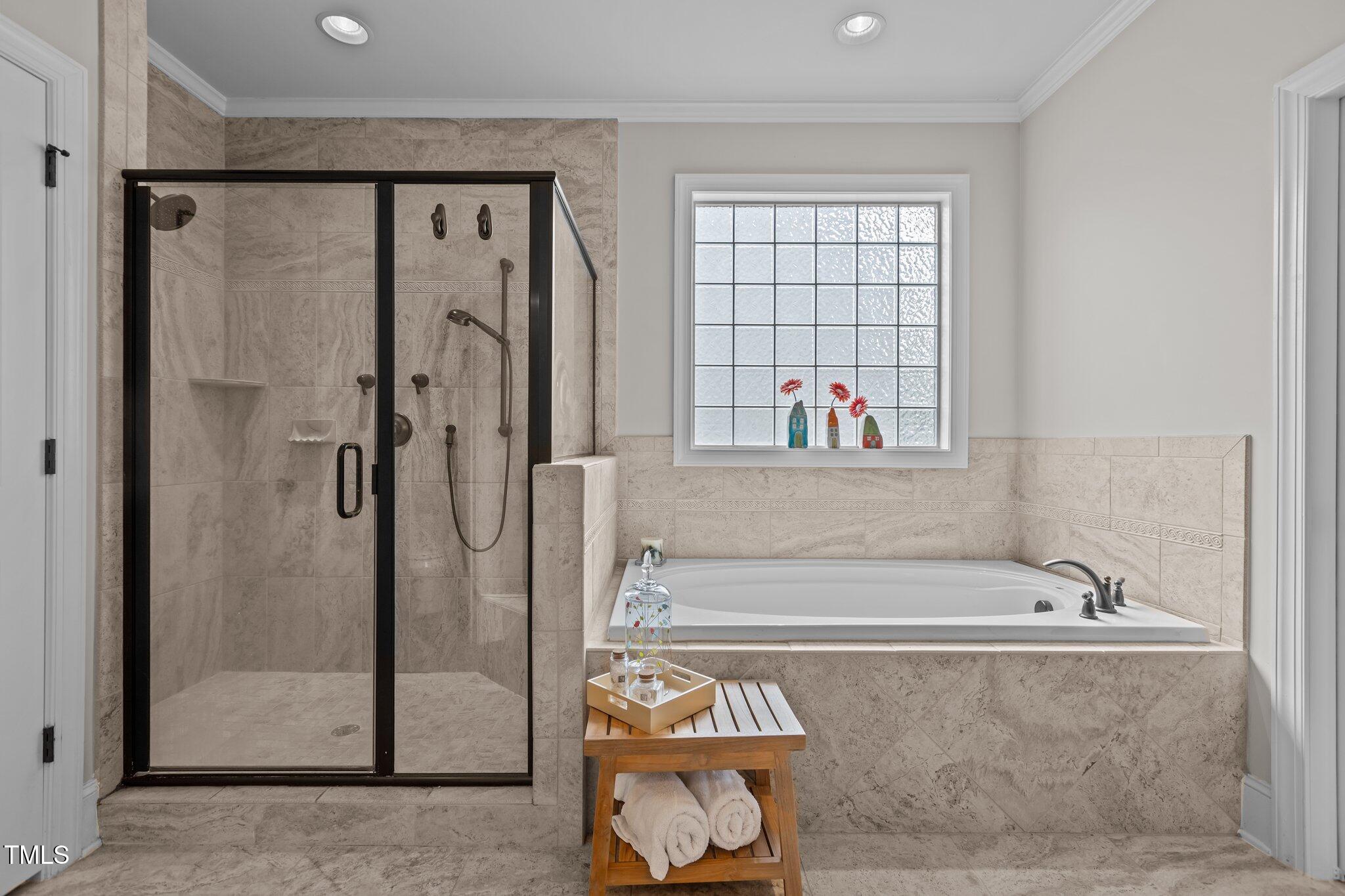 1512 Piazzo Court Apex, NC 27502 - Photo 22 of 59 a bathroom with a bathtub and a shower