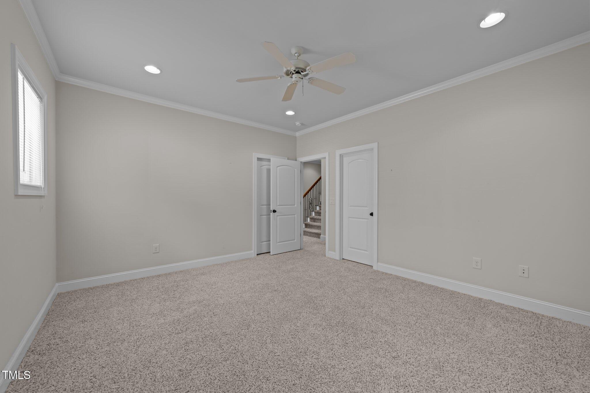 1512 Piazzo Court Apex, NC 27502 - Photo 27 of 59 a view of an empty room with a ceiling fan