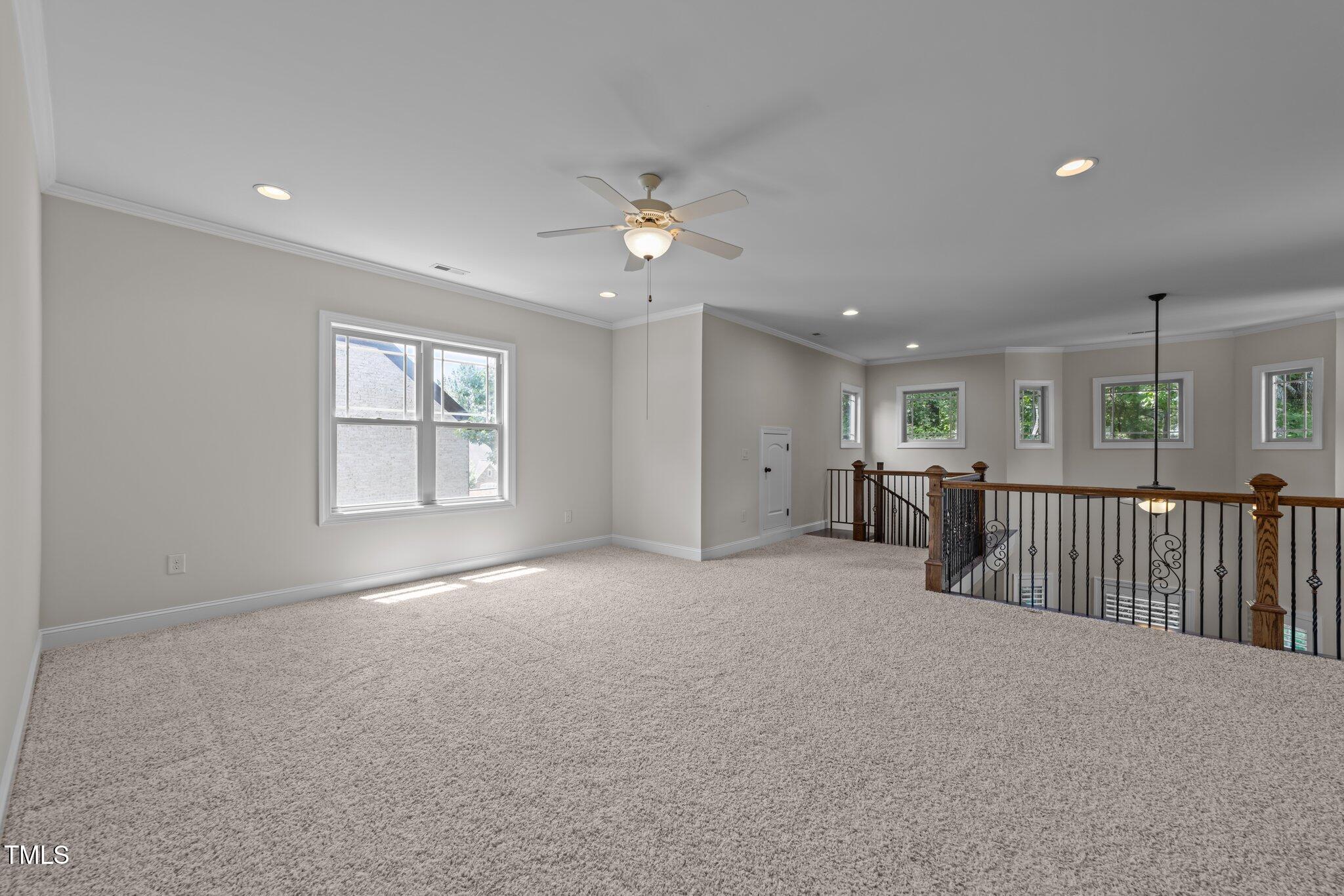 1512 Piazzo Court Apex, NC 27502 - Photo 39 of 59 en empty room with windows and ceiling fan