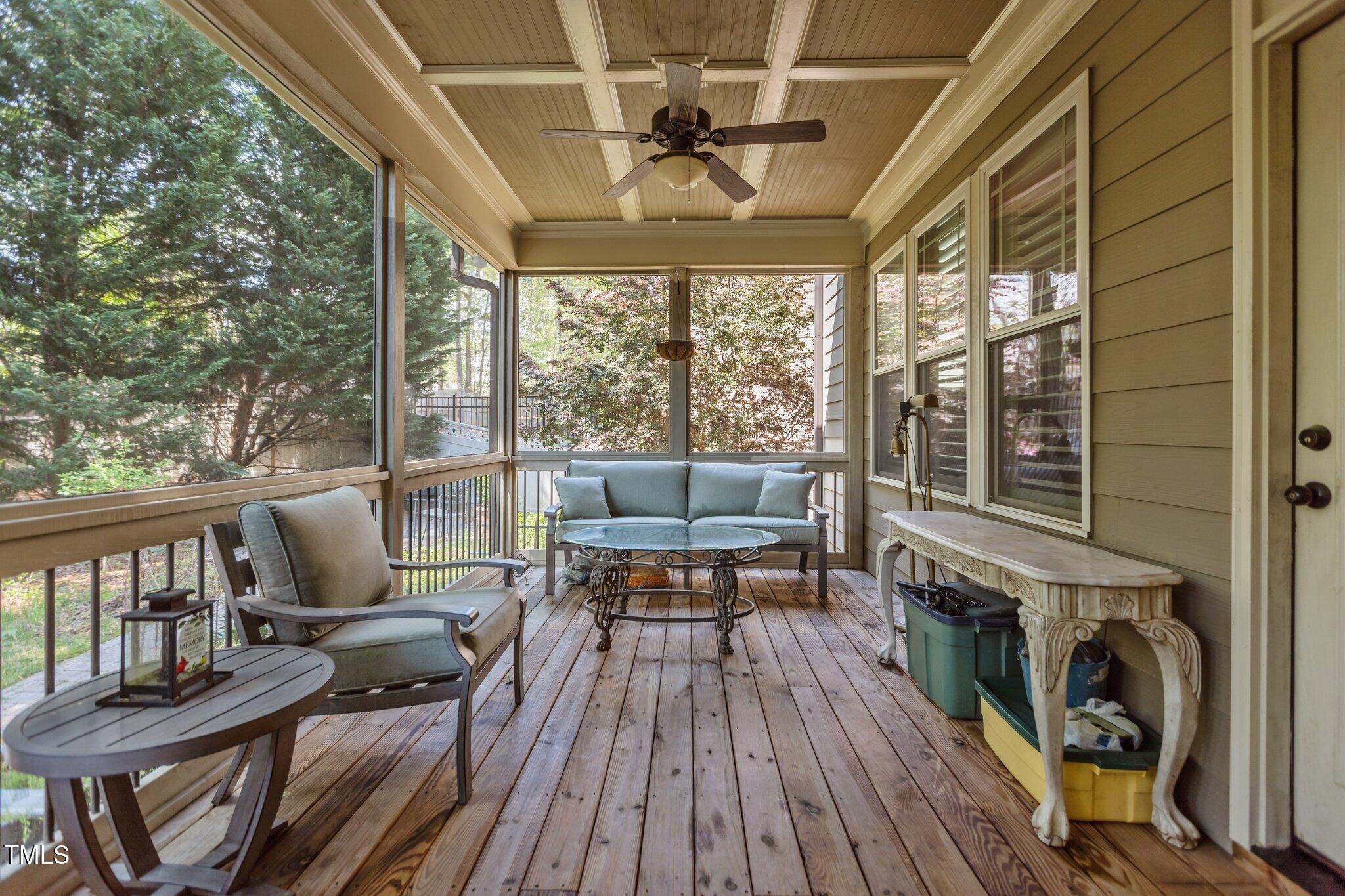 1512 Piazzo Court Apex, NC 27502 - Photo 43 of 59 a living room with furniture a fireplace and a floor to ceiling window