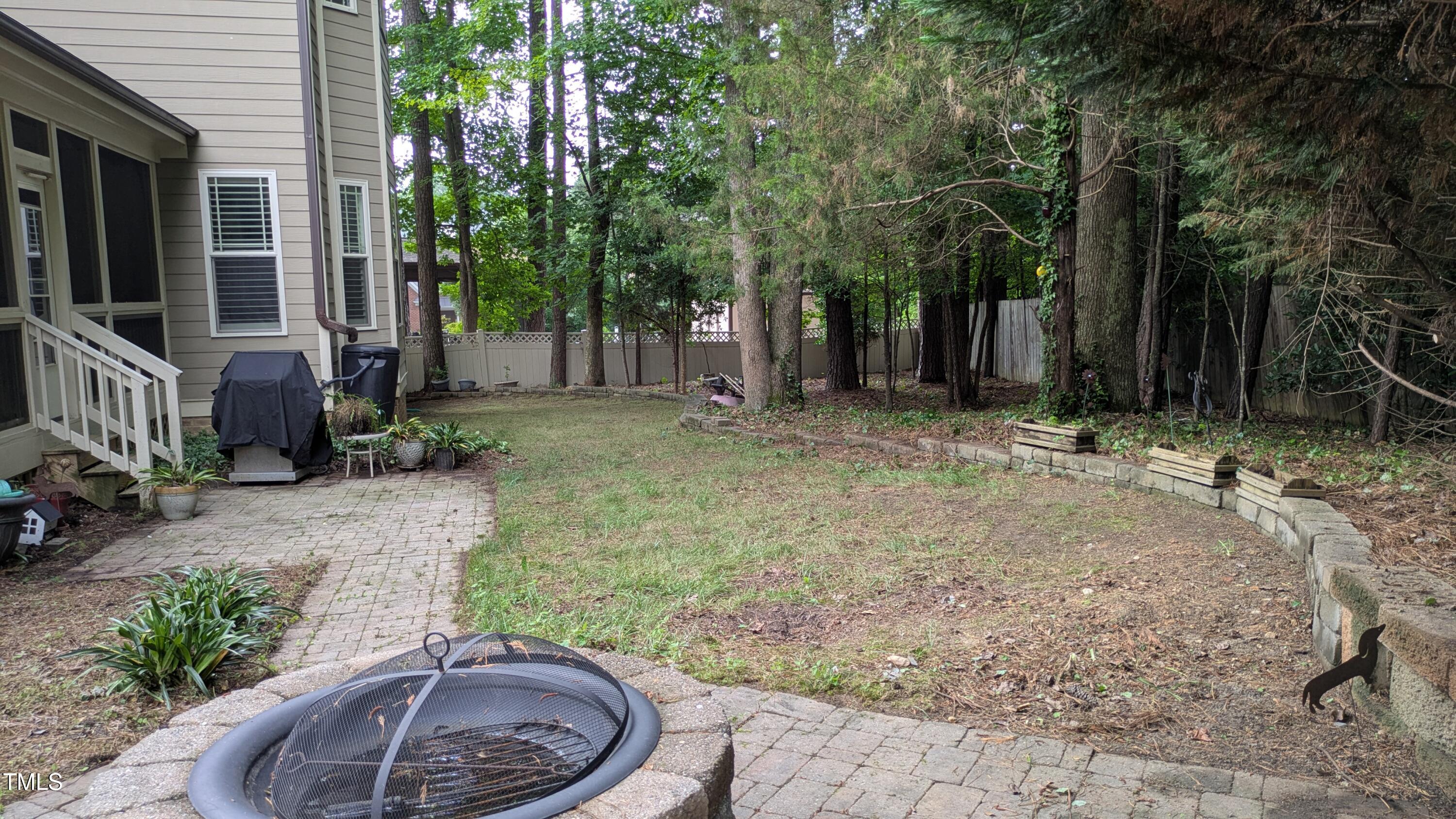 1512 Piazzo Court Apex, NC 27502 - Photo 46 of 59 a backyard of a house with fountain table and chairs