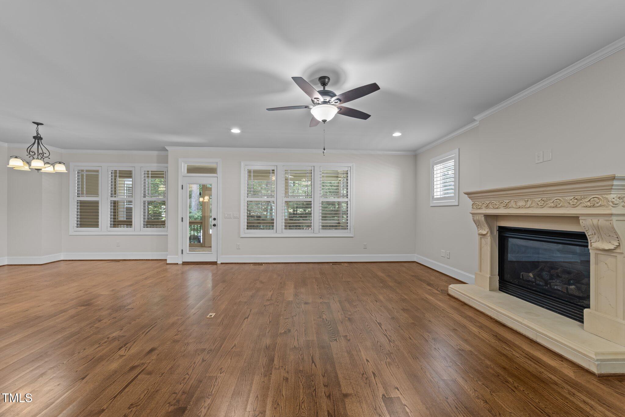 1512 Piazzo Court Apex, NC 27502 - Photo 5 of 59 a view of an empty room with wooden floor fireplace and a window