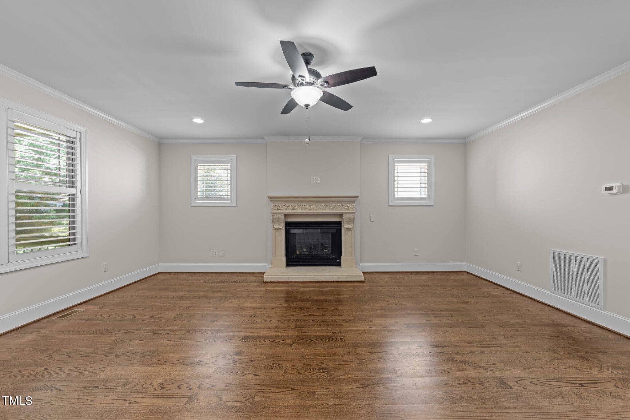 1512 Piazzo Court Apex, NC 27502 - Photo 6 of 59 an empty room with windows and a fireplace