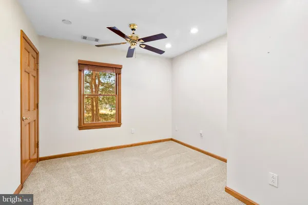 a patio with couches and a fire pit