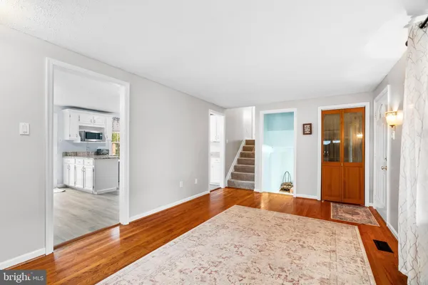 a bedroom with a bed and a large mirror on the dresser