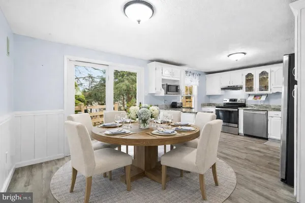 a view of a dining room with furniture window and wooden floor