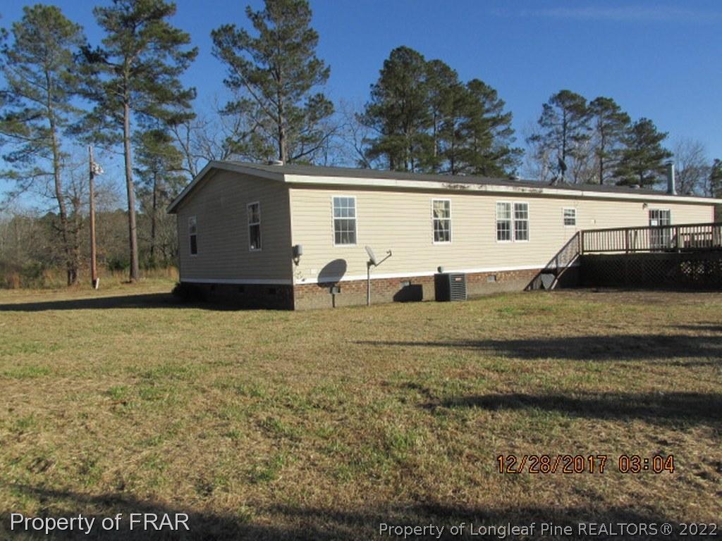 1127 Howell Road St. Pauls, NC 28384 - Photo 17 of 17 a view of a house with a yard