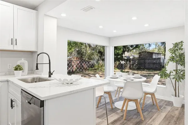 a kitchen with a table chairs and a sink