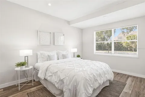 a bedroom with a bed and a lamp on table