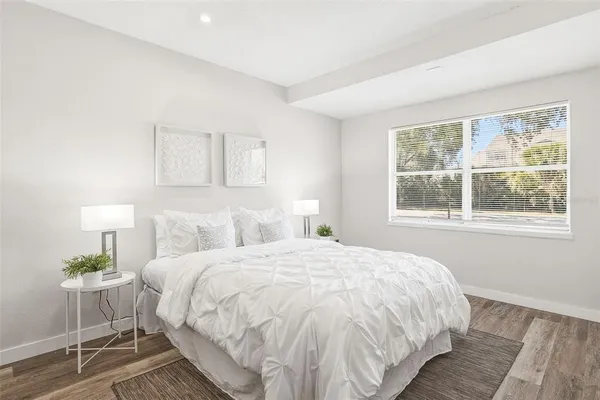 a bedroom with a bed and a lamp on table