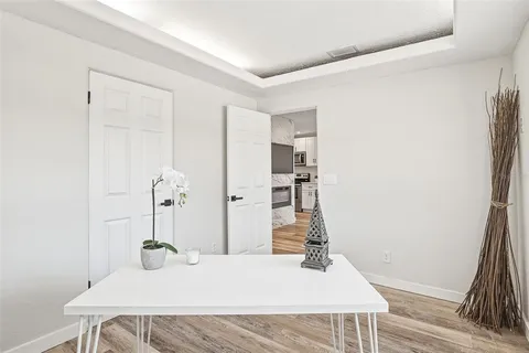 a bedroom with a bed and a wooden floor