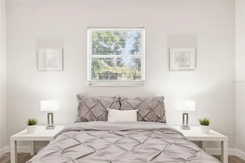 a bedroom with a bed and a lamp