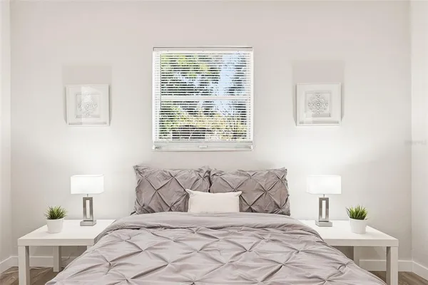 a bedroom with a bed and a lamp