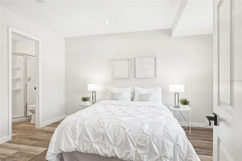 a bedroom with a bed and a night stand