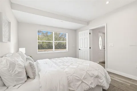 a bedroom with a bed and a window