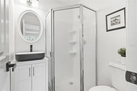 a bathroom with a toilet a sink and a mirror