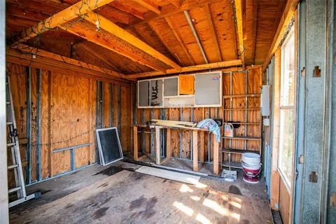a view of a porch with wooden floor and iron fence