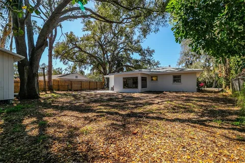 a view of a yard with a house and a tree
